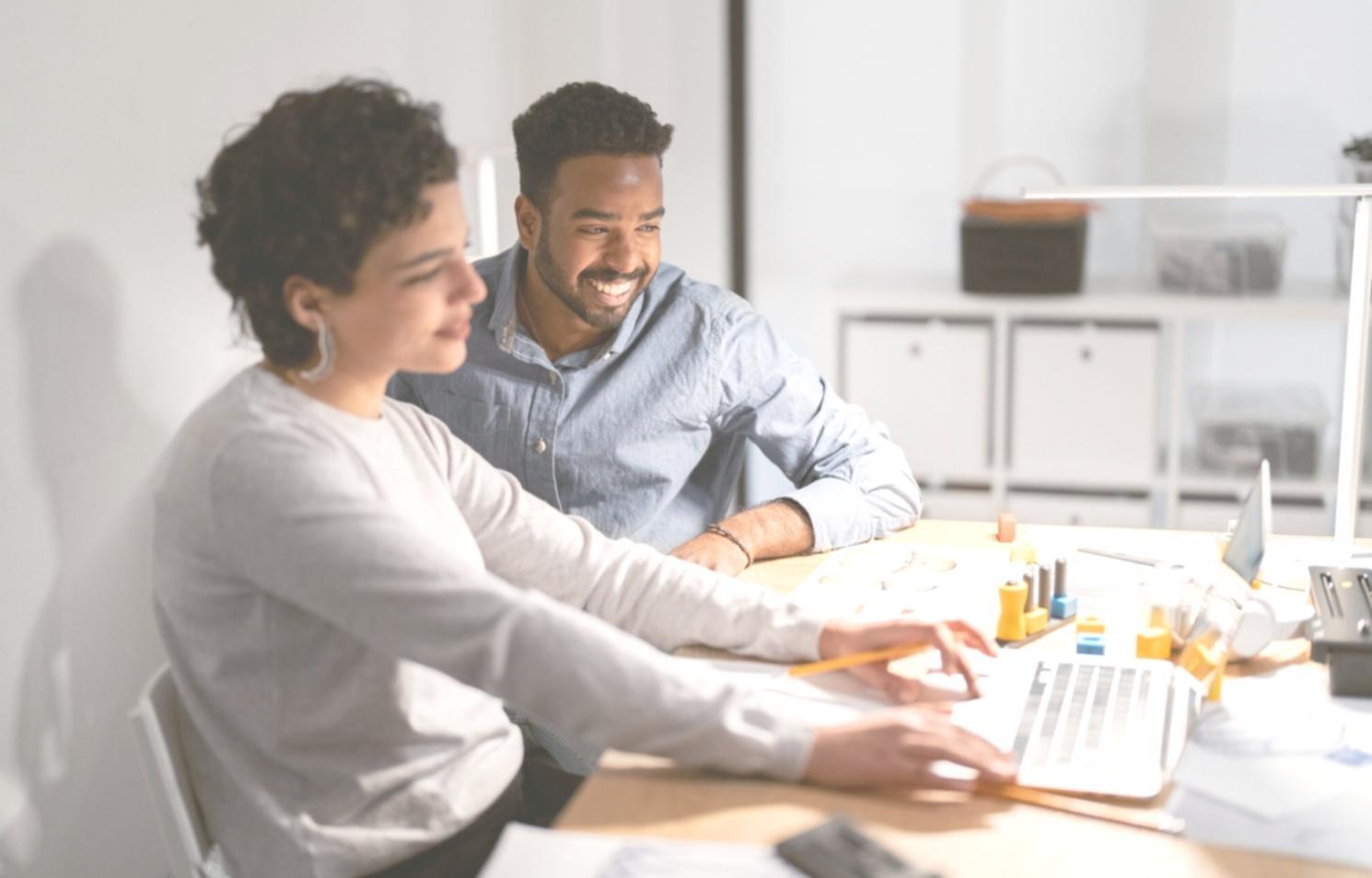 Business team analyzing financial scenarios on computer screens with charts and graphs